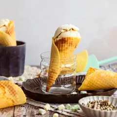 Eiswaffeln selber machen: goldbraune Waffeln mit Vanilleeis, Schokostreuseln und bunten Marshmallows.