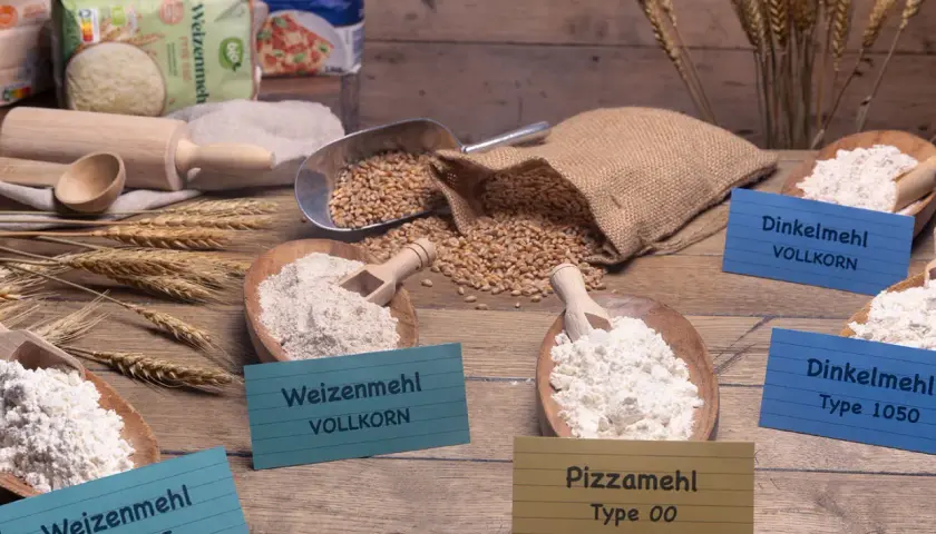 Verschiedene Mehlsorten, darunter Pizzamehl Type 00, Weizenmehl und Dinkelmehl. Die Frage, ob man mit Pizzamehl Kuchen backen kann, wird hier thematisiert.